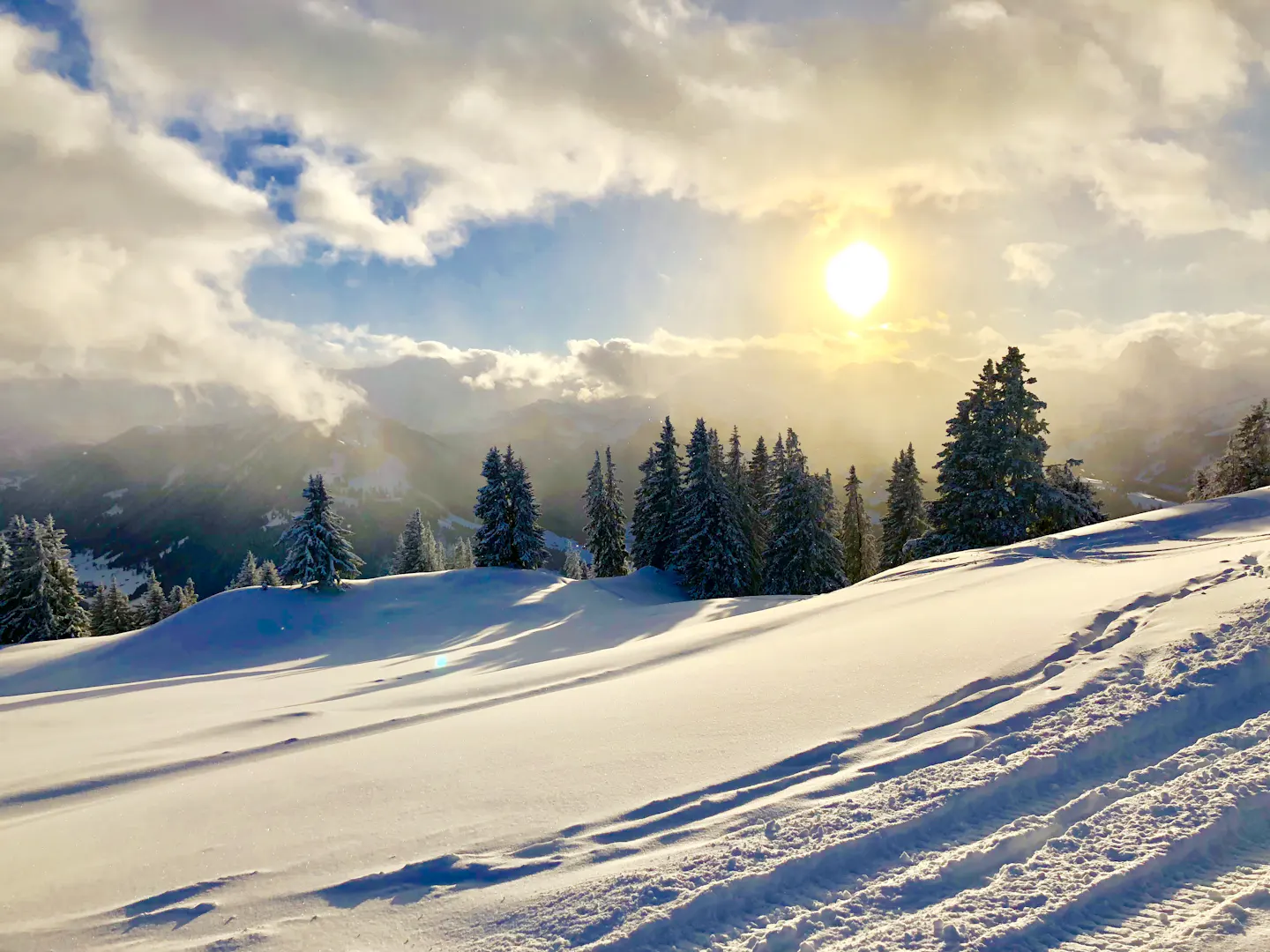 Winter sun over snowy slopes near Gstaad