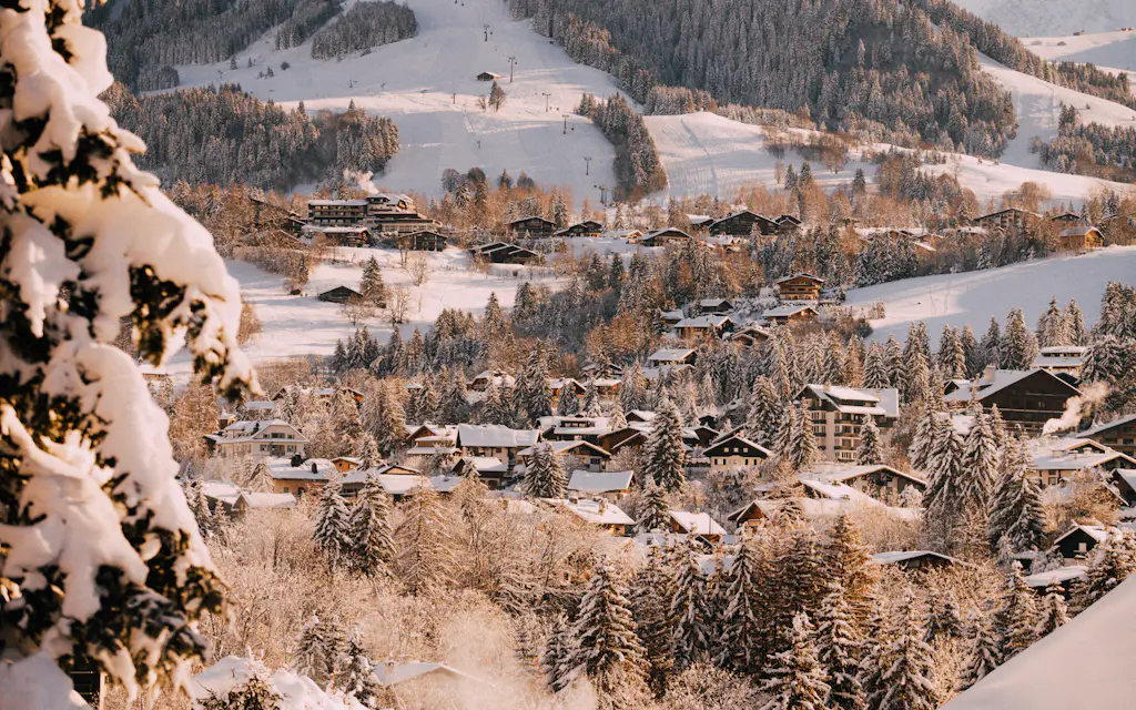 Snowy village and forest around Megève