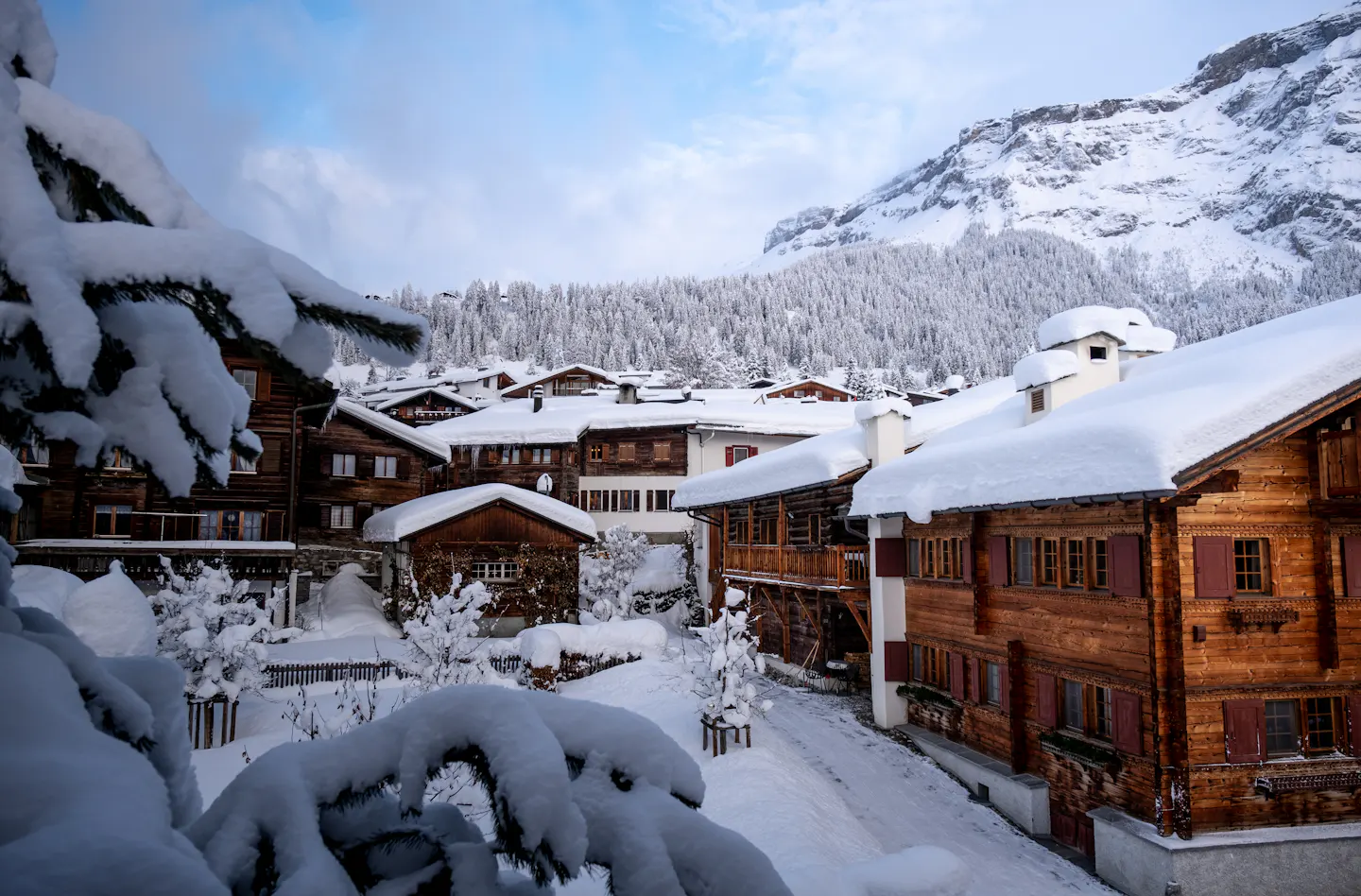 Snow-covered wooden chalets in an alpine ski village